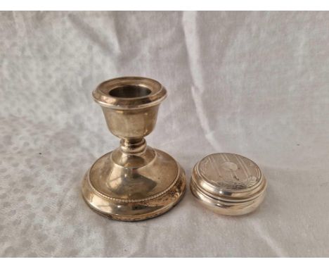 A decorative pill box with gilt interior, Birmingham 1957 and a candlestick