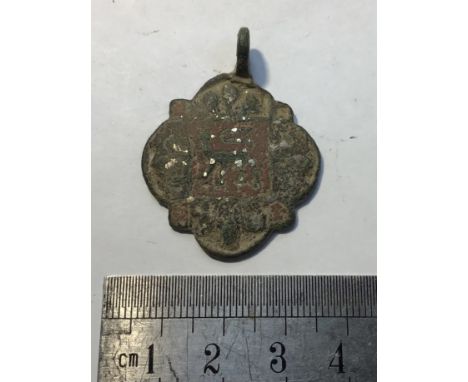Medieval copper alloy horse harness pendant. Image portrays a centrally located Royal lion inside a box surrounded by a quatr