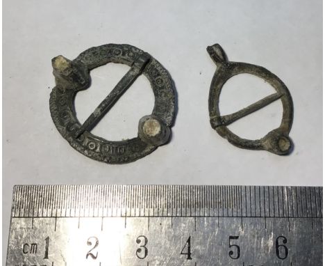 Pair of medieval turret ring brooch. 13th-14th century. Copper alloy annular broochs largest being a 2 turret brooch with whi