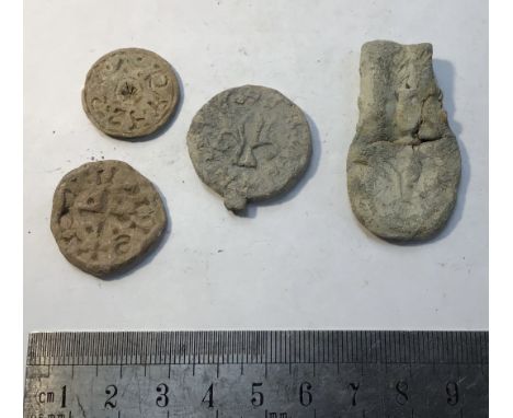 Collection of medieval lead artefacts including a scalloped pilgrims ampula with the letter &ldquo;R&rdquo; and a trio of rou