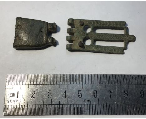 Two item lot containing (1)Roman copper alloy decorated buckle plate. W10.54g. 47.8mm x 22mm. (2)Copper alloy square strap en