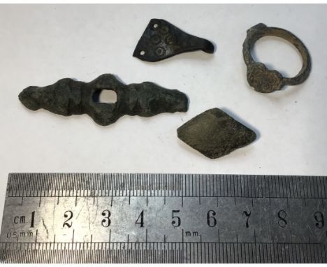 Collection of copper alloy Saxon artefacts including a silver inlay seal ring and zoomorphic dagger quillion.