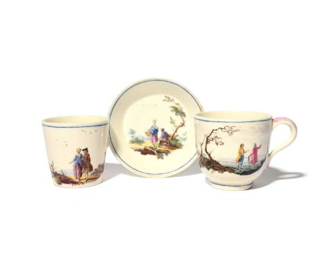 Two Mennecy cups and a saucer, c.1755, the larger cup painted with two travellers conversing in a landscape, the smaller of f