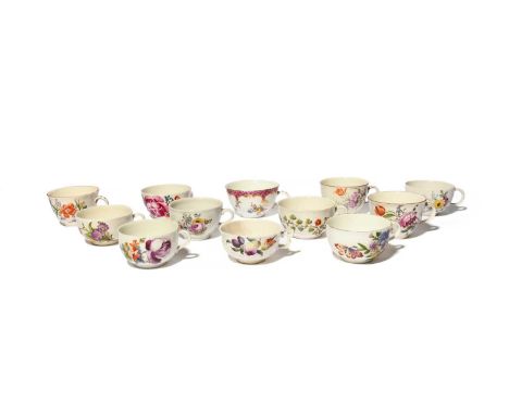 Twelve Continental porcelain teacups, c.1760-90, variously painted with fruit and flowers, two with additional moulded decora