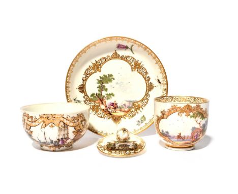 A matched Meissen coffee cup and saucer, c.1740, painted with shaped panels of figures in landscapes within elaborated gilt a