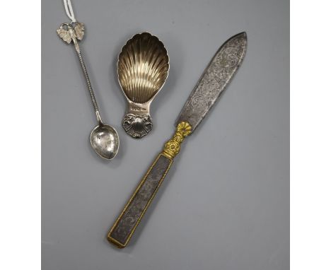 A silver shell caddy spoon, a Ceylonese white metal spoon and a 19th century steel and ormolu letter opener