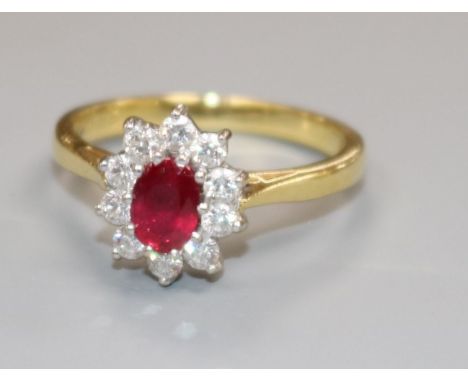 A modern 18ct gold, ruby and diamond cluster ring, size L.