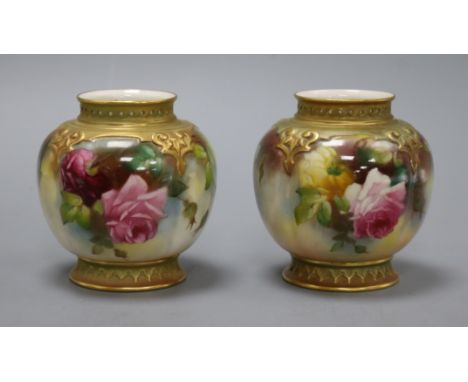 A pair of Royal Worcester vases, decorated with roses H.9.5cm