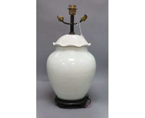 A Chinese white glazed porcelain jar and cover, late 19th/early 20th century, mounted as a lamp H.57.5cm