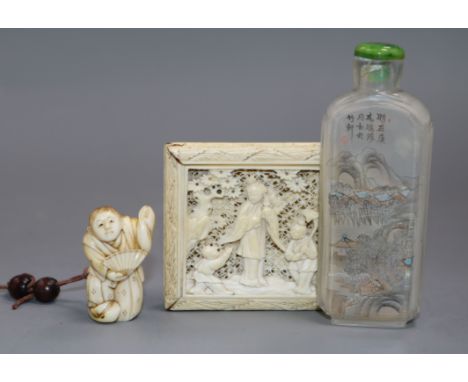 A Chinese ivory tangram puzzle, an ivory netsuke and a pressed amber rhino