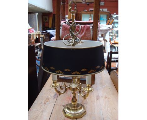 A reproduction brass three branch French Empire style table lamp with Toleware style shade, 74cm high.