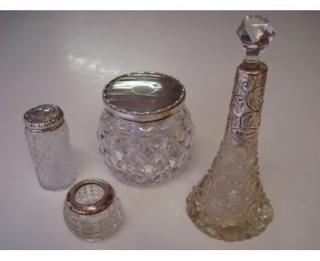 Four examples of early 20th Century silver topped cut glassware to include a 1905 perfume decanter by John Henry Wynn of Birm