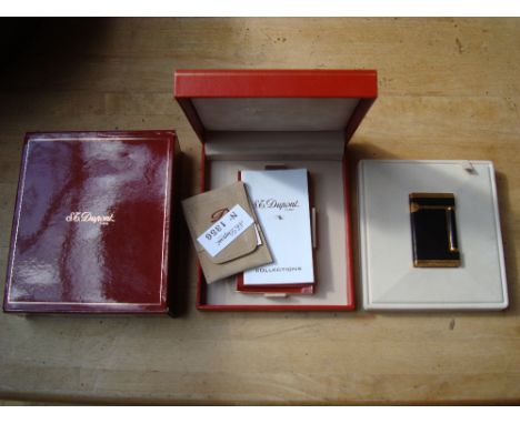 An S.T.Dupont of Paris ''Normandy'' lighter in black laque de chine. Boxed, with original paperwork and a fitted case.