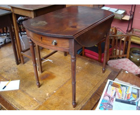 A George III mahogany oval pembroke table, with bow fronted frieze drawers and on ring turned tapering legs. 