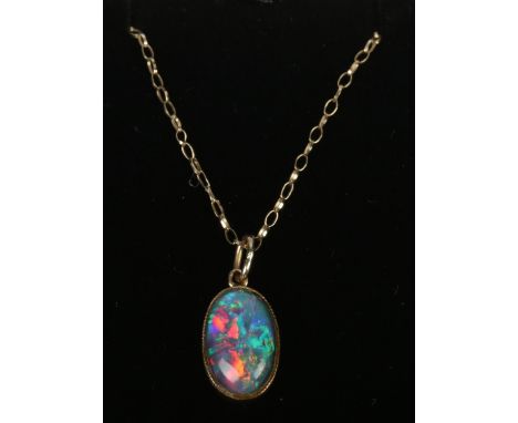 An opal doublet pendant on 9ct gold chain.  