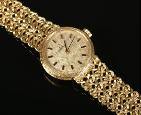 A vintage ladies 18ct gold Omega manual wristwatch on 18ct gold strap. In original box with papers. (39g gross weight).  Runn