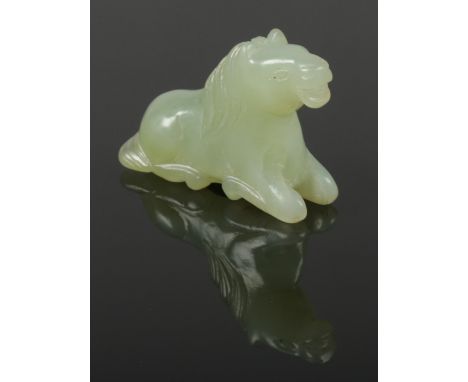 A small carved jade figure of a recumbent horse. Length 6.5cm Height 4cm.  