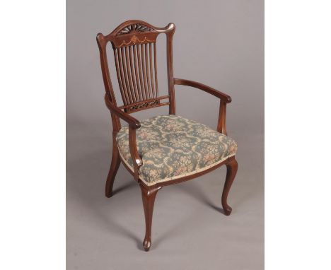 An Edwardian inlaid mahogany comb back arm chair.  