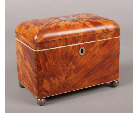 A Victorian tortoise shell tea caddy with a hinged lid and two sections to the interior. 14cm x 18cm x 11cm  