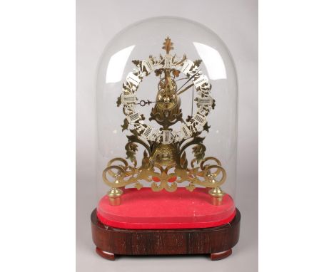 An eight day Victorian brass fusee skeleton  mantel clock with silvered chapter ring. Housed under a glass dome and supported