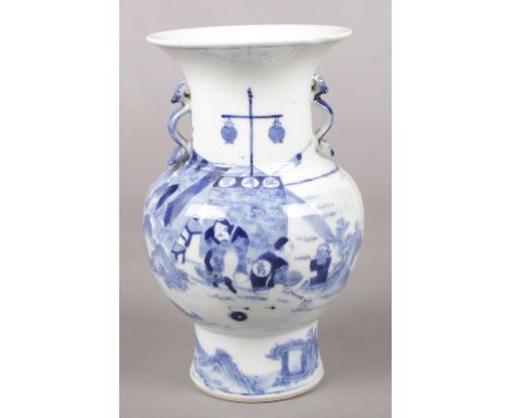 A 19th century Chinese blue and white vase. With twin handles formed as Ruyi Sceptres and painted in under glaze blue with pa