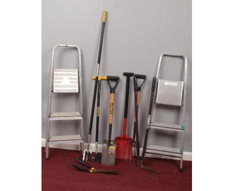 A group of garden tools &amp; two metal step ladders. Spades, forks, hoes etc.  