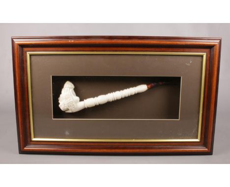 A large decorative Meerschaum pipe in frame.  