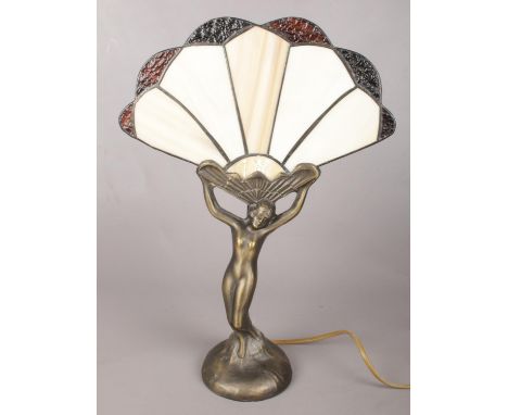 An art deco style figural table lamp with fan shape shade.  Shade cracked to the bottom.