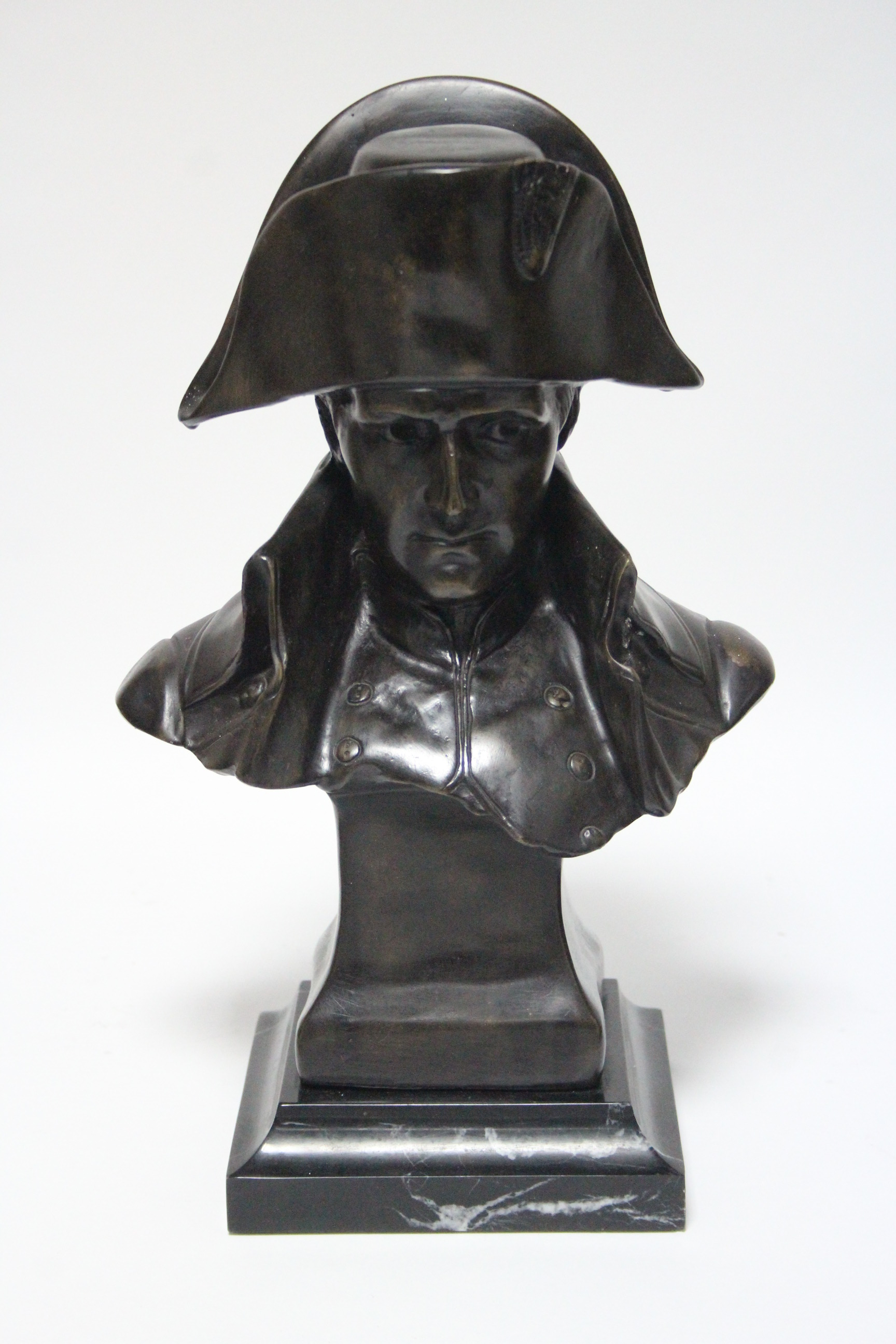 A bronze bust of Napoleon, signed to the back “Le comte 82”, on black ...