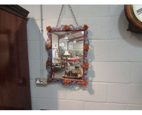 A modern mirror with bead and wire floral decoration, 65cmx 47cm
