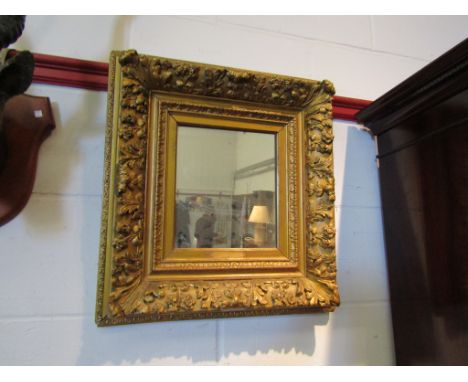 An ornate gilt framed wall mirror, 45cm x 50cm overall