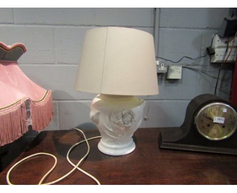 A cream table lamp applied with floral detail, with shade