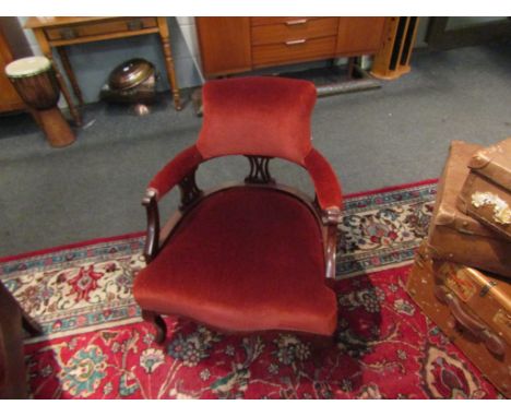 A late Victorian mahogany yoke back tub chair with pierced splats over cabriole fore legs, 72cm tall