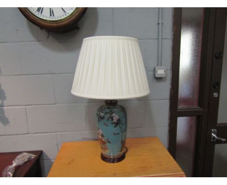 A table lamp in the form of a ginger jar depicting a peacock and other birds, with pleated shade