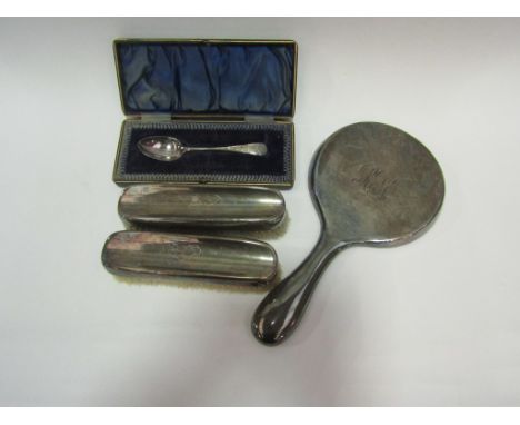 A silver dressing table bevel edged mirror, two brushes, Birmingham, and a cased silver spoon, Sheffield (4)