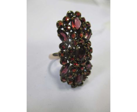 A garnet set plaque ring