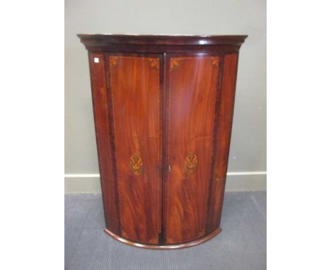 George III inlaid mahogany bow front corner cupboard with key