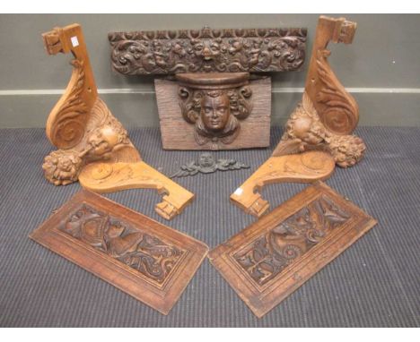 Pair of oak carved cherub wall brackets; a frieze panel; and a cherub mask wall bracket (4)