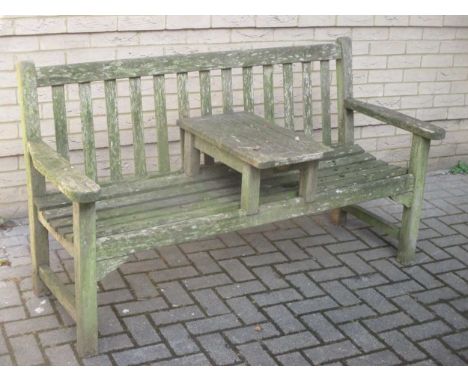 A teak garden bench with central table
