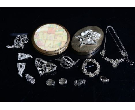 A group of marcasite brooches, clip-on earrings, a compact, and pillbox 