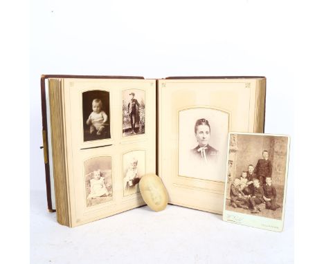 A Victorian leather-bound family photograph album, mostly full with portrait photographs and silhouettes 