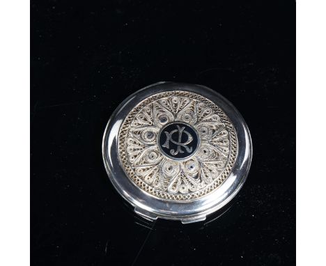A Middle Eastern unmarked white metal niello compact, filigree decoration, with duck in flight, signed, diameter 7cm 