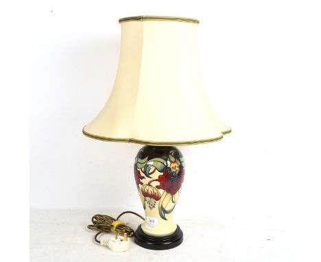 A Moorcroft cream ground table lamp, with tube-lined floral decoration, and shade, height overall 60cm 