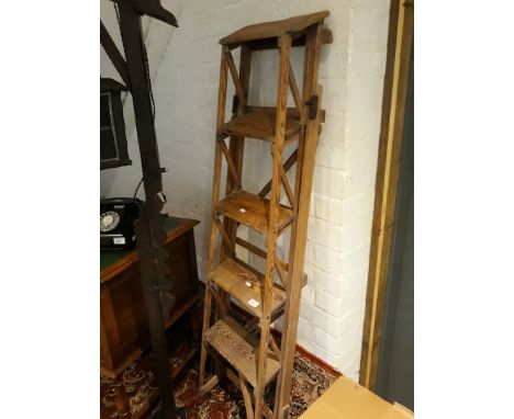 A pair of vintage wooden step ladders. 