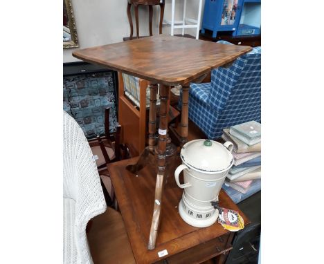 A flip top tripod table. 