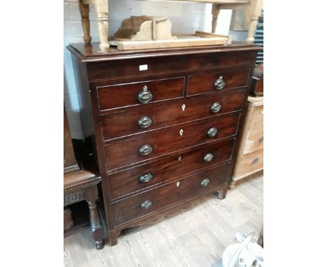 A 19th Century mahogany chest of drawers with loop brass handles having Neo-Classical style detail, bone escutcheons and brac