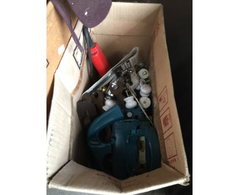 A box of tools and ceramic knobs 