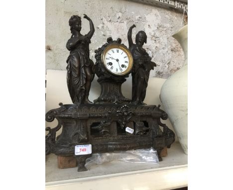 A metal clock with key and pendulum 