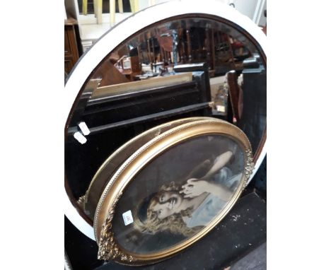 A portrait in an oval gilt frame and a round mirror. 