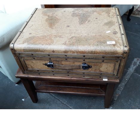 A decorated trunk with drawer on stand. 